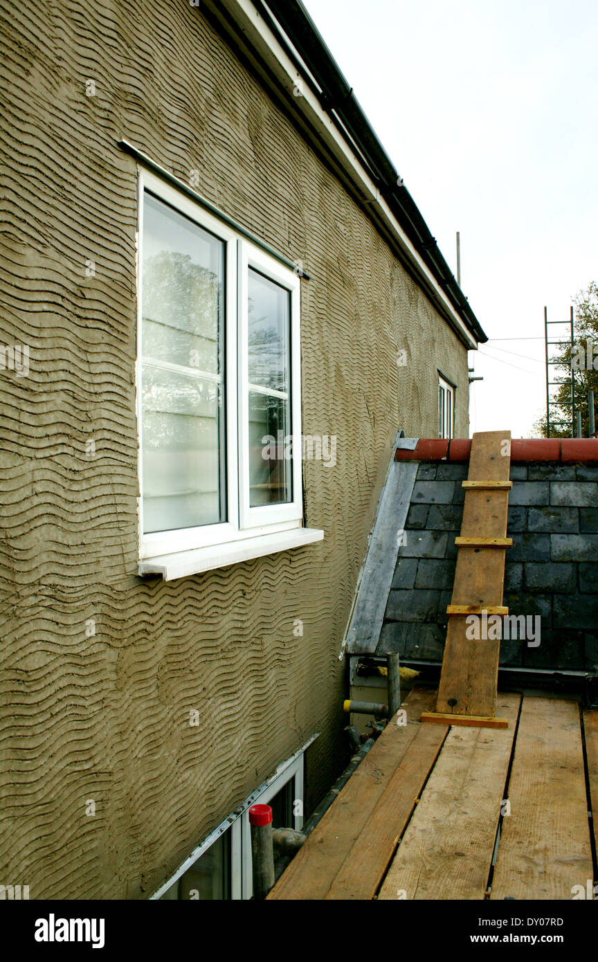Lato della casa che mostra la nuova base in cemento sgommati pronto per applicazioni di rendering o gesso Foto Stock