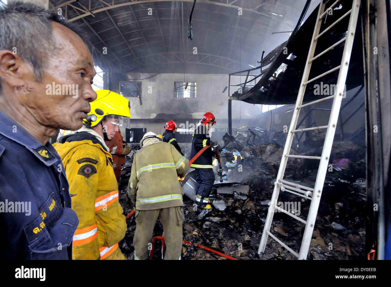 Bangkok, Tailandia. 2 Apr 2014. I vigili del fuoco di spegnere un incendio causato da un'esplosione in un metallo di scarto in magazzino il Bang Khen distretto a Bangkok, Thailandia, 2 aprile 2014. Una bomba è creduto di essere dalla II guerra mondiale periodo esplosa nella capitale thailandese Bangkok Mercoledì, lasciando almeno 7 morti e 19 altri feriti. Il 225-chilogrammo bomba è esplosa quando un lavoratore a un metallo di scarto in magazzino il Bang Khen distretto ha tentato di tagliarlo aperto, che presumibilmente non ha capito che era una bomba. Credito: Rachen Sageamsak/Xinhua/Alamy Live News Foto Stock