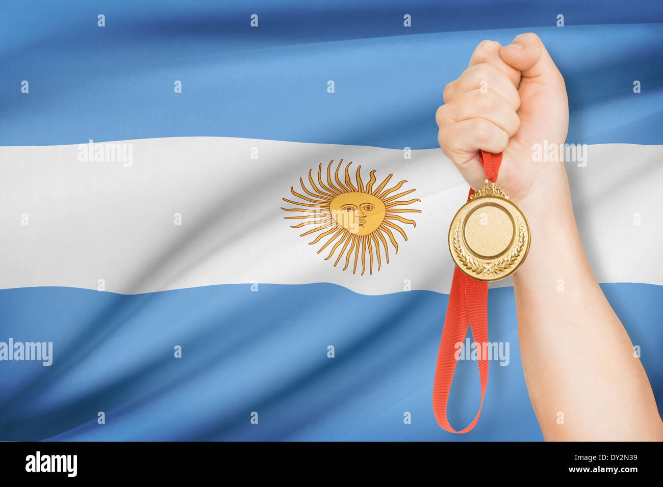 Sportivo tenendo la medaglia d'oro con bandiera su sfondo - Repubblica argentina Foto Stock