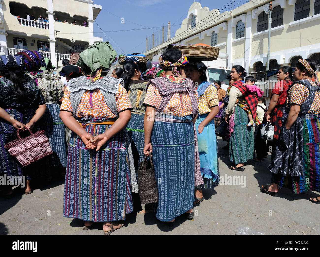 Le donne in attesa dei mezzi di trasporto al mercato di frutta e verdura in Almolonga. San Pedro de Almolonga, Repubblica del Guatemala. Foto Stock