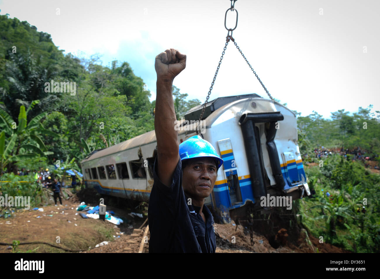 Tasikmalaya, West Java. 5 apr, 2014. Un treno lavoratore fornisce un segnale per l'operatore della gru durante l'evacuazione del deragliato Malabar treno a Tasikmalaya, West Java, Indonesia il 5 aprile 2014. Frane sostenute dagli acquazzoni pesanti causato un treno deragliato in Tasikmalaya di West Java su Venerdì sera, uccidendo 5 persone, funzionario detto qui. Credit: Veri Sanovri/Xinhua/Alamy Live News Foto Stock