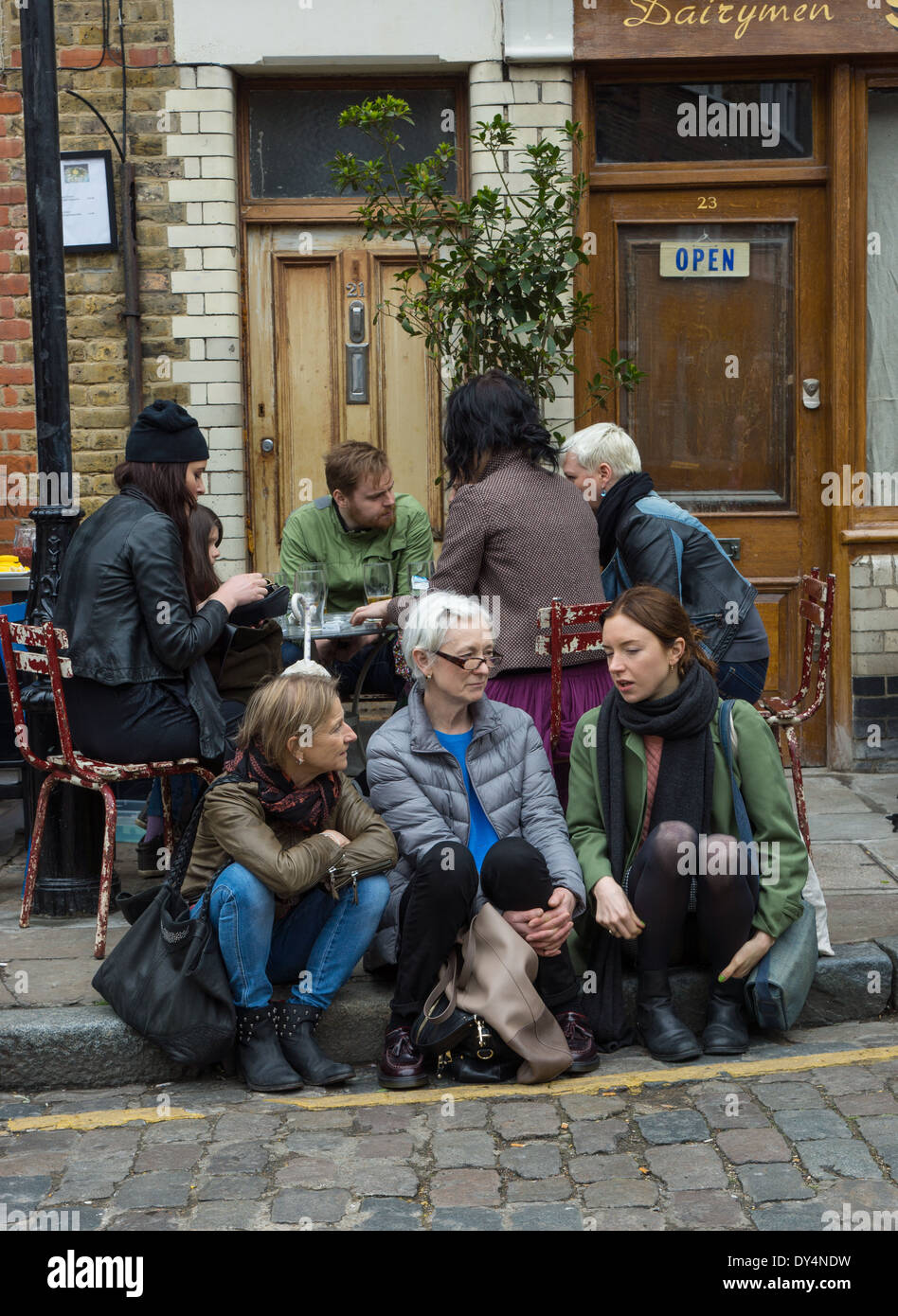 Gruppo di persone che vivono al di fuori di un pub di Londra Foto Stock