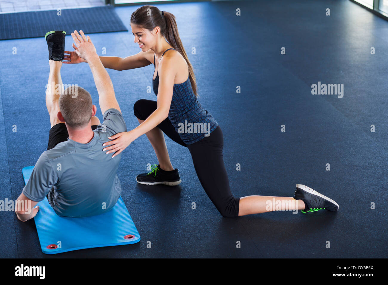 Giovane che si aiutano reciprocamente in palestra Foto Stock