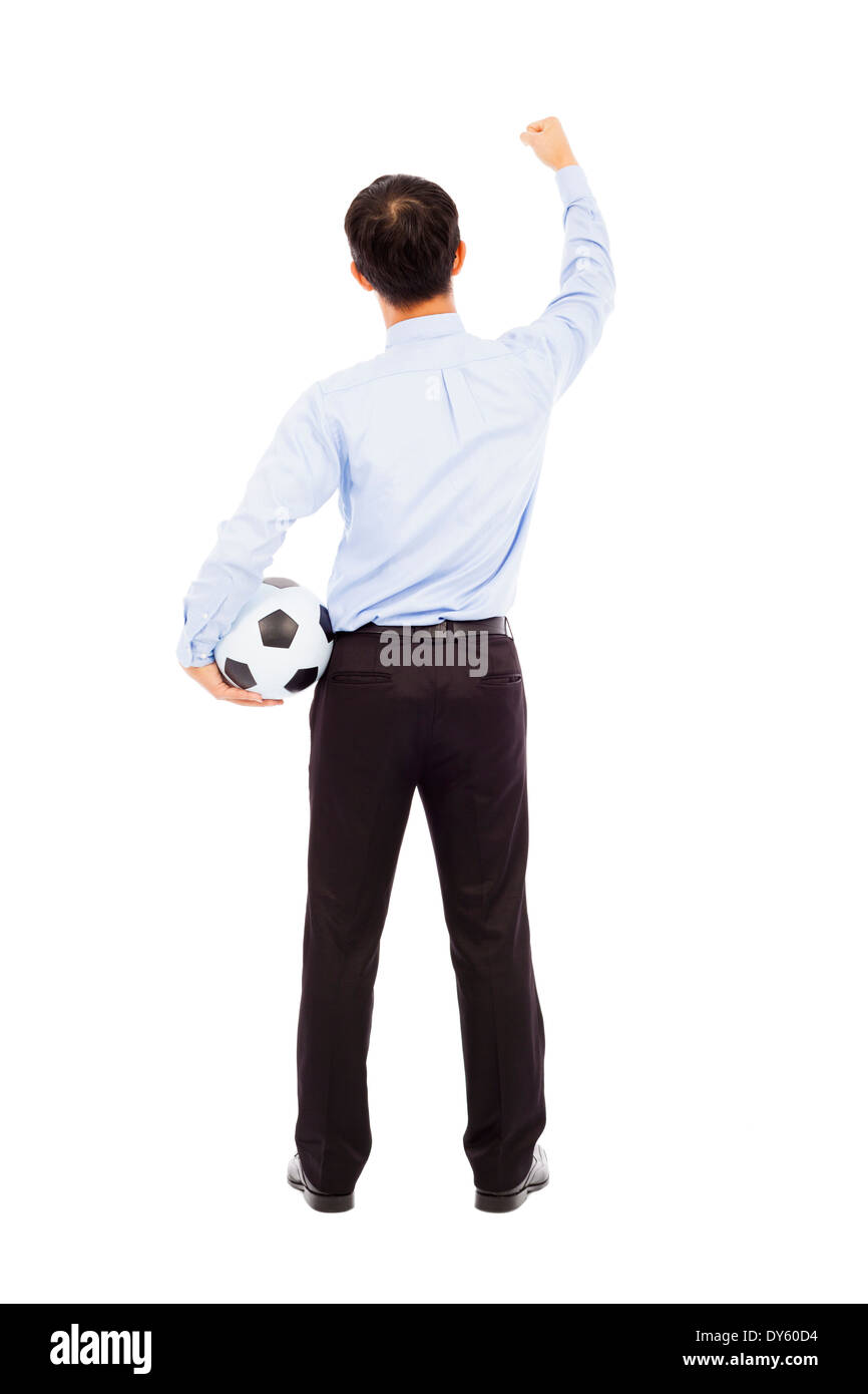 Vista posteriore del giovane imprenditore tenere una palla in studio Foto Stock