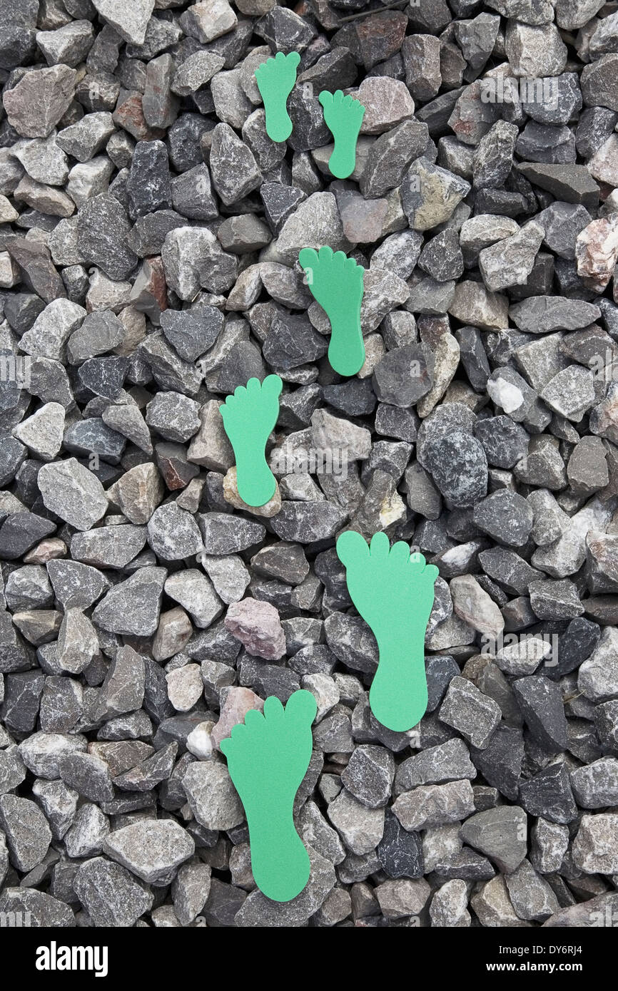 Schiuma verde piedi stampe mostra impronta di carbonio Foto Stock