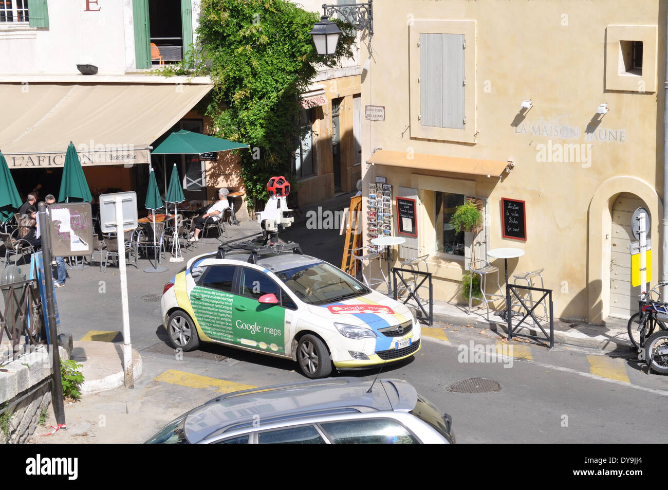 Un auto con la telecamera montata a scattare foto per Google Maps guida attraverso le zone turistiche di Arles vicino a Anfiteatro Romano Foto Stock