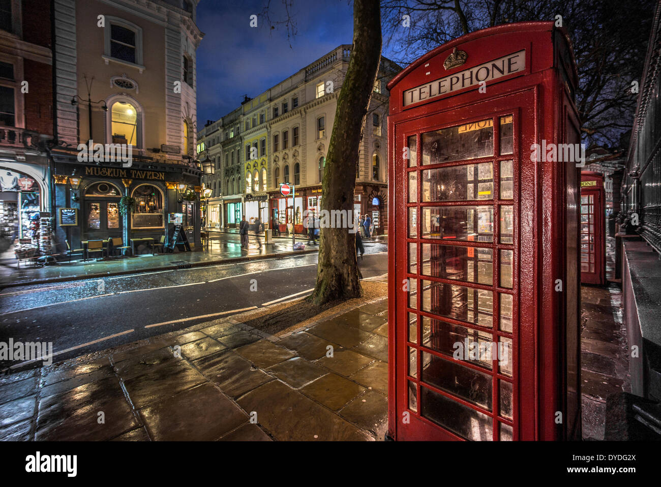 Un telefono rosso scatola su Museum Street a Londra di notte. Foto Stock