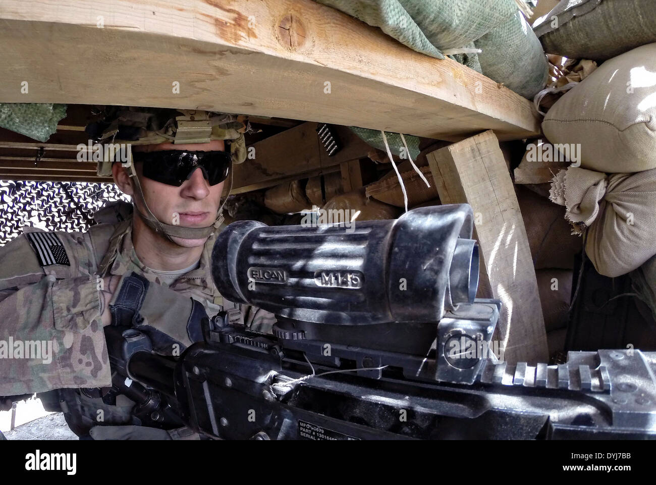 US Army Spc. Aaron cerve sorge guardare da un bunker sandbagged 18 aprile 2014 al posto di osservazione inglese, provincia di Logar, Afghanistan. Foto Stock