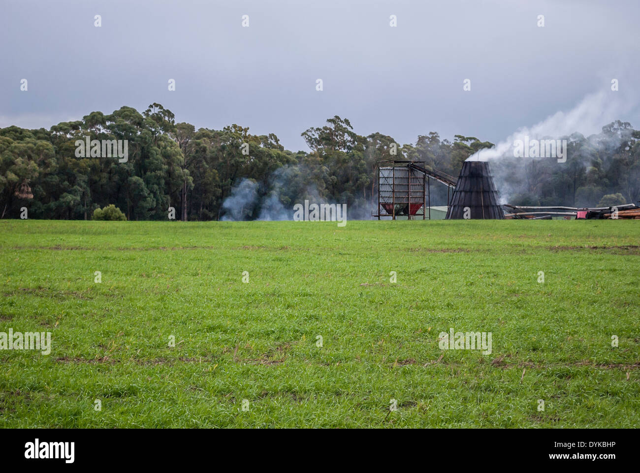 Un inceneritore di rifiuti di disboscamento che emette fumo a East Gippsland Victoria Australia Foto Stock