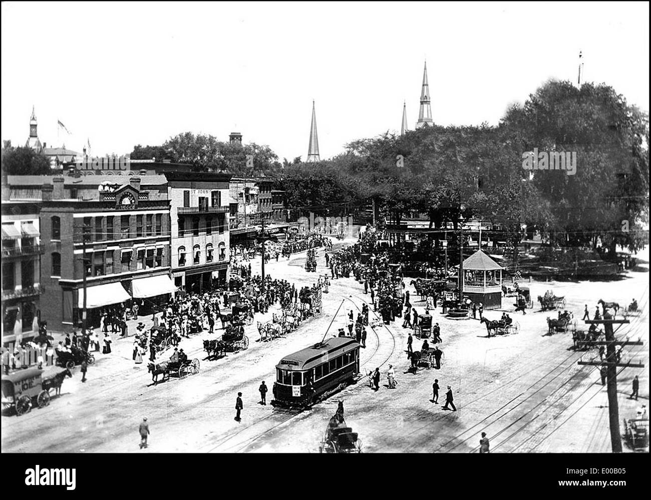 Una fotografia storica di Main Street, West Side e Central Square a Keene, New Hampshire, degli anni '1900 L'immagine cattura il quartiere degli affari con vagoni ferroviari elettrici, carrozze trainate da cavalli e vivaci vetrine, mettendo in risalto la miscela di vita urbana e trasporto dell'epoca. Foto Stock