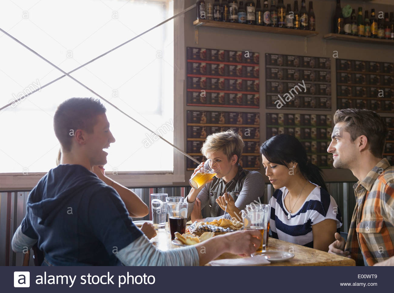 Gli amici di mangiare e di bere alla birreria Foto Stock