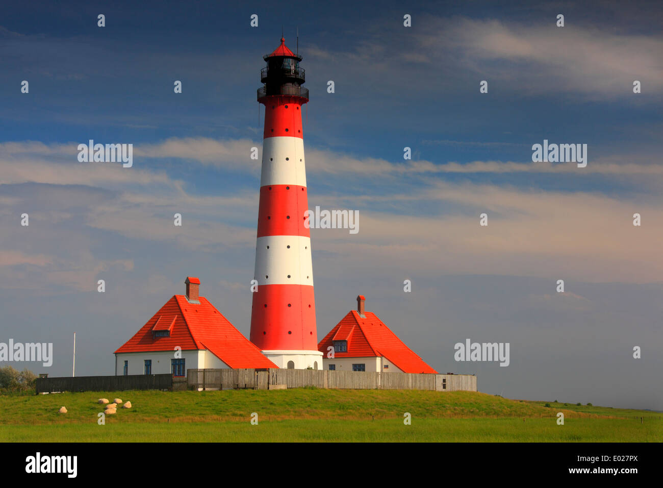 Foto della rossa e bianca a strisce westerheversand faro con la tempesta del Cielo e nubi, penisola di eiderstedt, Germania Foto Stock