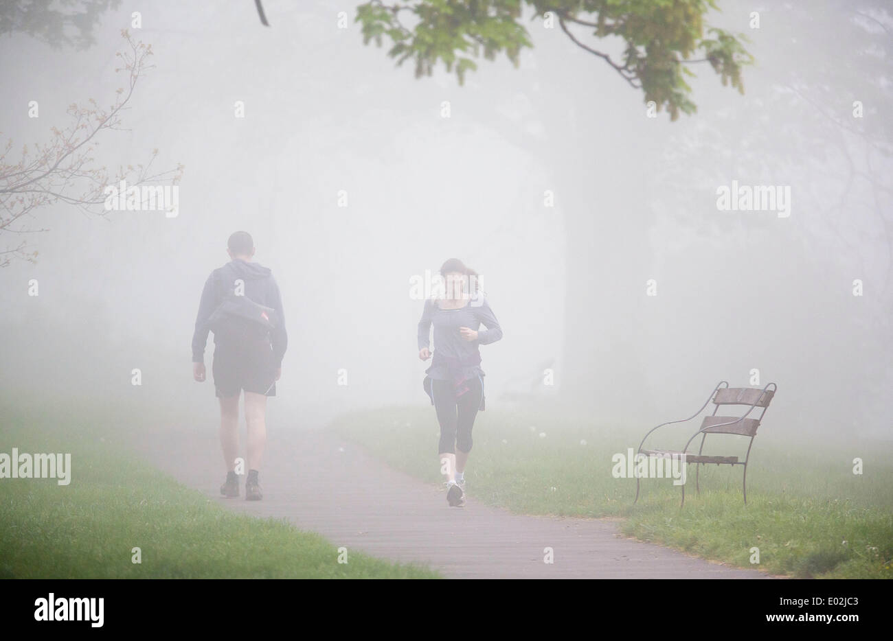 Bristol, Regno Unito. 30 apr 2014. Per gli amanti del jogging mattutino corrono attraverso la fitta nebbia in Bristol. Il Met Office ha rilasciato un giallo allarme meteo per il sud dell'Inghilterra e del Galles a causa di fitta nebbia - che ha portato alla distruzione di mattina i voli a Londra e Bristol. 30 aprile 2014 Credit: Adam Gasson/Alamy Live News Foto Stock
