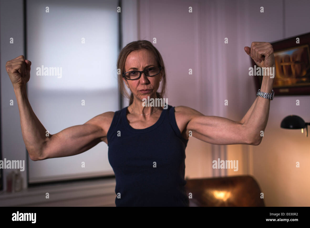 Una donna forte con bracci tonico e rinserrata pugni. Foto Stock