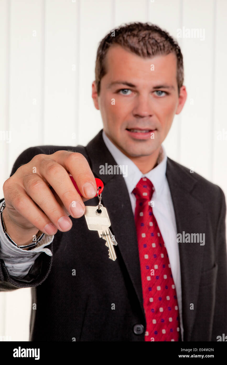 Di successo veramente mediatori immobiliari con la chiave di un piatto, Erfolgreicher Immobilien Makler Schluessel mit einer Wohnung Foto Stock