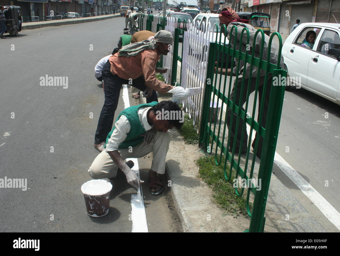 Srinagar, Indiano Kashmir amministrato. 03 Maggio 2014 : Non musulmani pittori pantaloni strade e sentieri pareti in srinagar durante l'apertura del 5 maggio questo mese ogni anno, segretariato civile, con circa 7.000 mployees, si muove a Srinagar in e estati a Jammu in inverni. Documenti ufficiali come migliaia di file vengono trasportati in autobus e camion su 300 km Jammu-Srinagar lungo l'autostrada nazionale. L'intero esercizio costi il cash-strapped membro a whopping 100 Rs crore ogni anno. un coprifuoco in corso. © sofi suhail/Alamy Live News Foto Stock