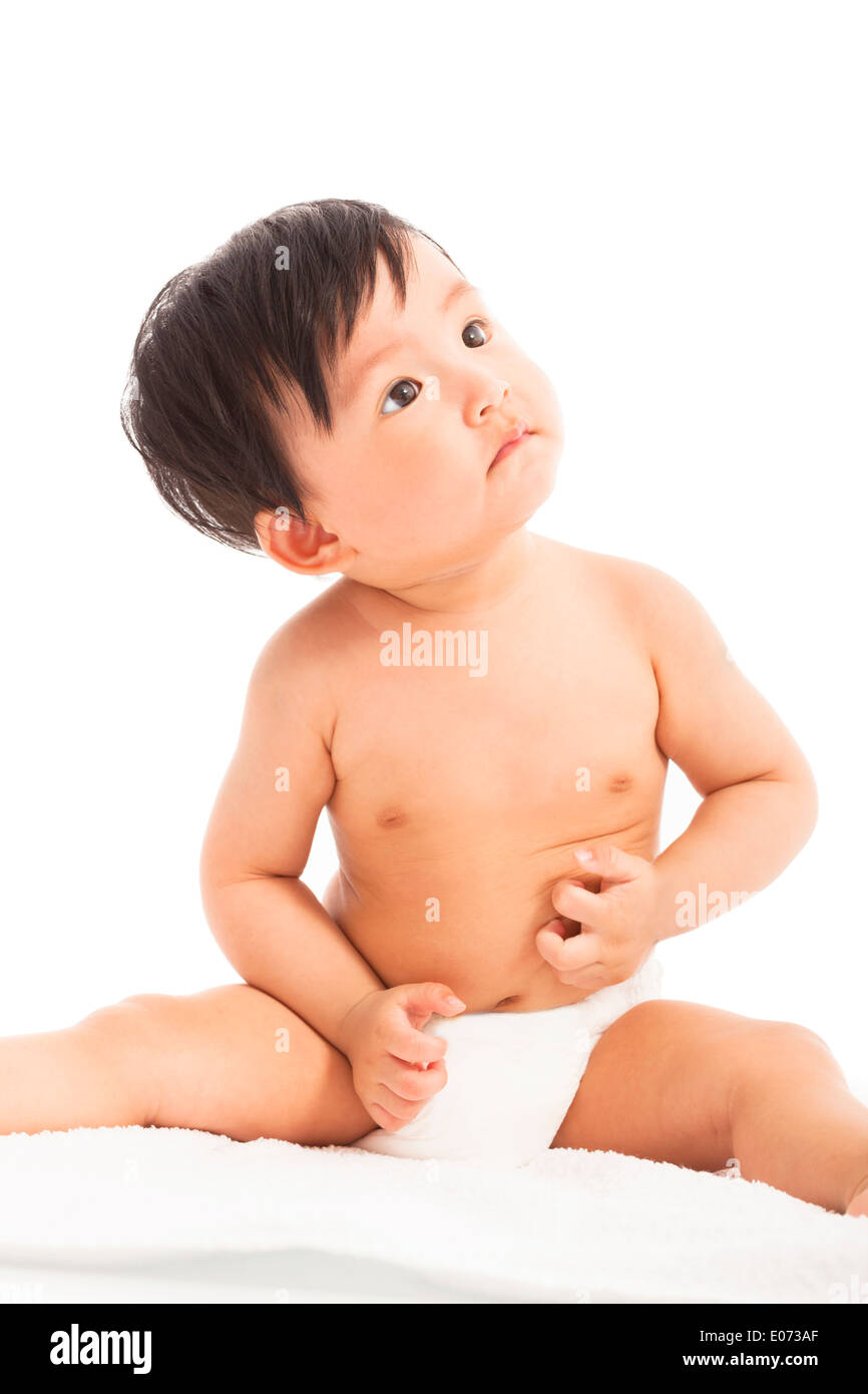 Curioso Neonato Bimbo Baby sitting e guardare in alto Foto Stock
