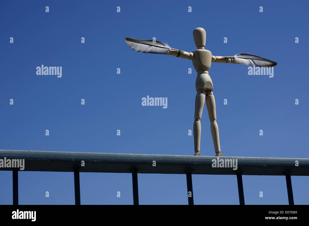 Berlino, Germania. 21st luglio, 2013. Illustrazione - le piume sono attaccate alle braccia di un manichino di legno sulla ringhiera del ponte Warschauer Bruecke nel quartiere Friedrichshain di Berlino, Germania, 21 luglio 2013. La figura raffigura Icarus, figlio del maestro artigiano Daedalus, che nella mitologia greca tentò di fuggire da Creta per mezzo di ali che il padre costruì da piume e cera, ma poi cadde in mare ignorando le istruzioni di non volare troppo vicino al sole. Fotoarchiv für Zeitgeschichte - NO WIRE SERVICE/dpa/Alamy Live News Foto Stock