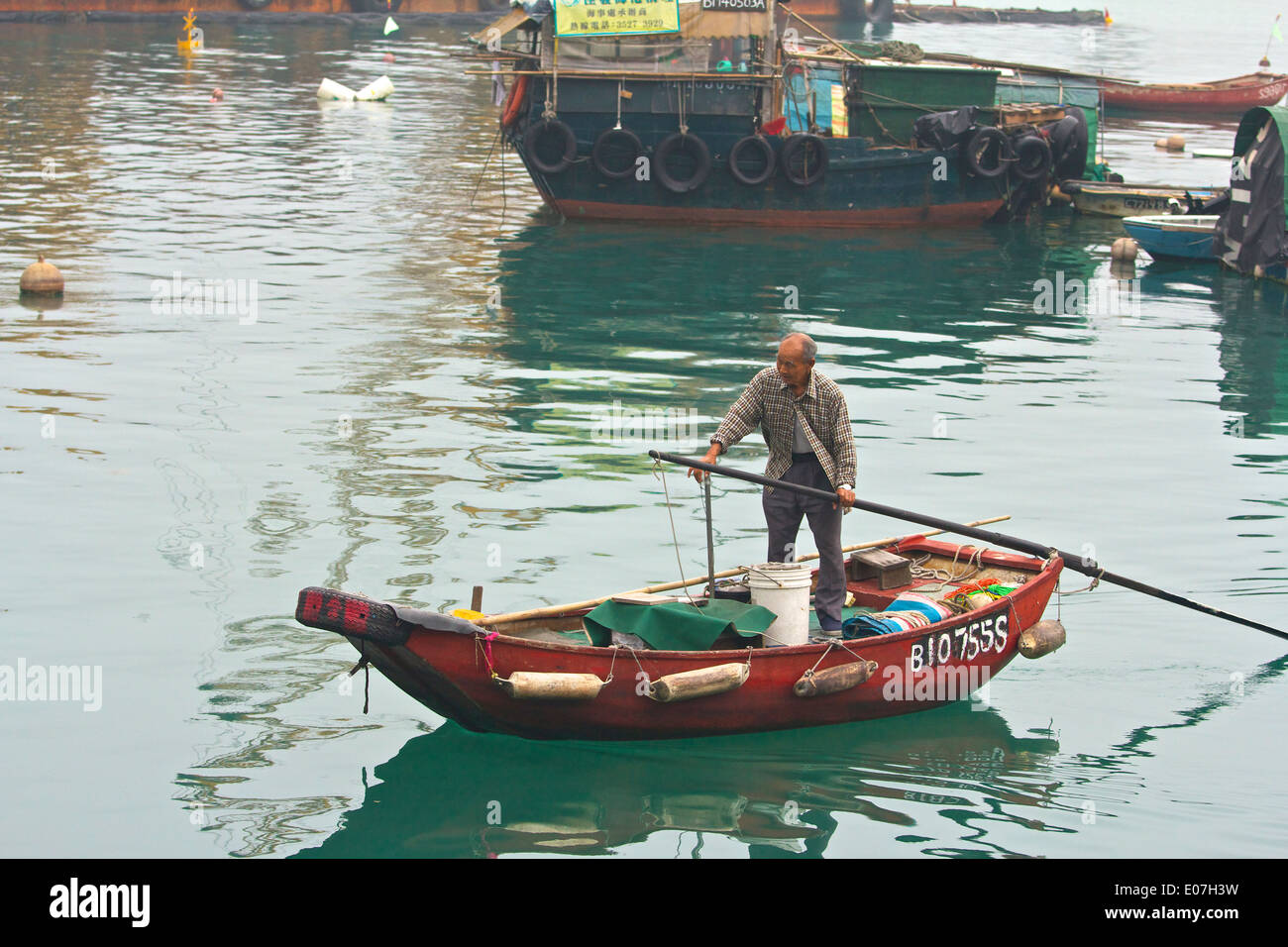 Anziani uomo cinese file attraverso il Causeway Bay Typhoon Shelter. Hong Kong. Foto Stock