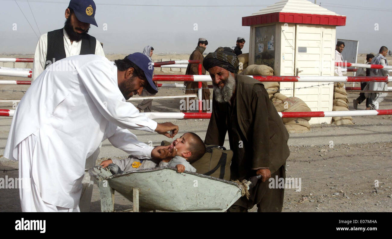 Salute worker amministra la polio-vaccino scende al di sotto di un bambino durante il anti-polio campagna di immunizzazione al confine Pak-Afghan in Chaman lunedì 05 maggio, 2014. L Organizzazione Mondiale della Sanità (OMS) ha raccomandato di restrizioni di viaggio sul Pakistan, in Siria e in Camerun per un mancato controllo della diffusione del virus polio. Se la raccomandazione dell'OMS è approvato sarà obbligatorio per i cittadini di questi paesi che hanno una vaccinazione antipolio certificato quando sono in viaggio all'estero. Foto Stock