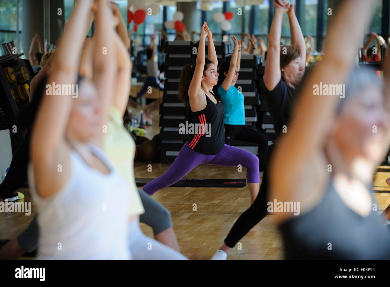 La gente lo stiramento durante lo Yoga lezione di fitness in palestra Foto Stock