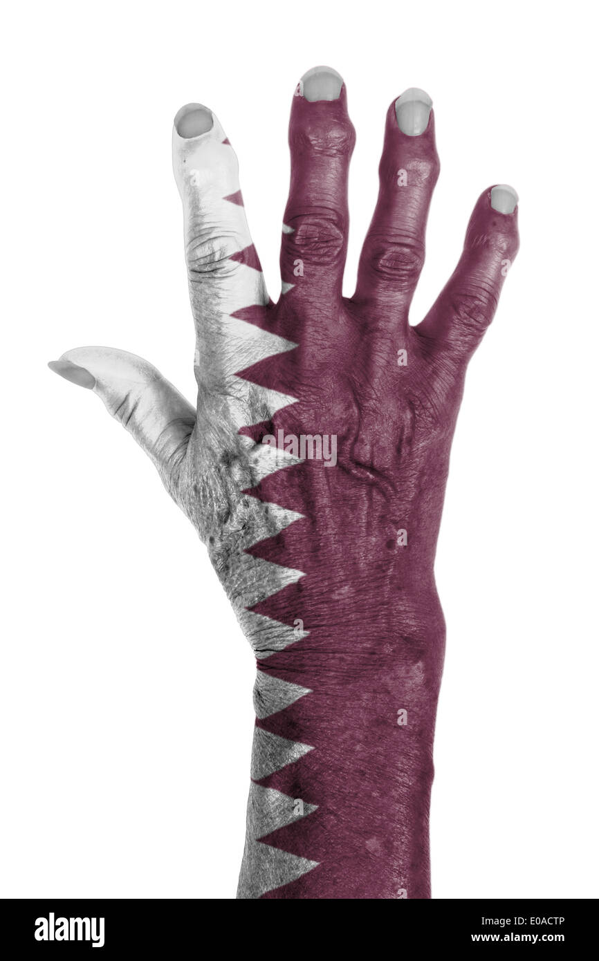 La mano di una vecchia donna avvolta nella bandiera del Qatar Foto Stock