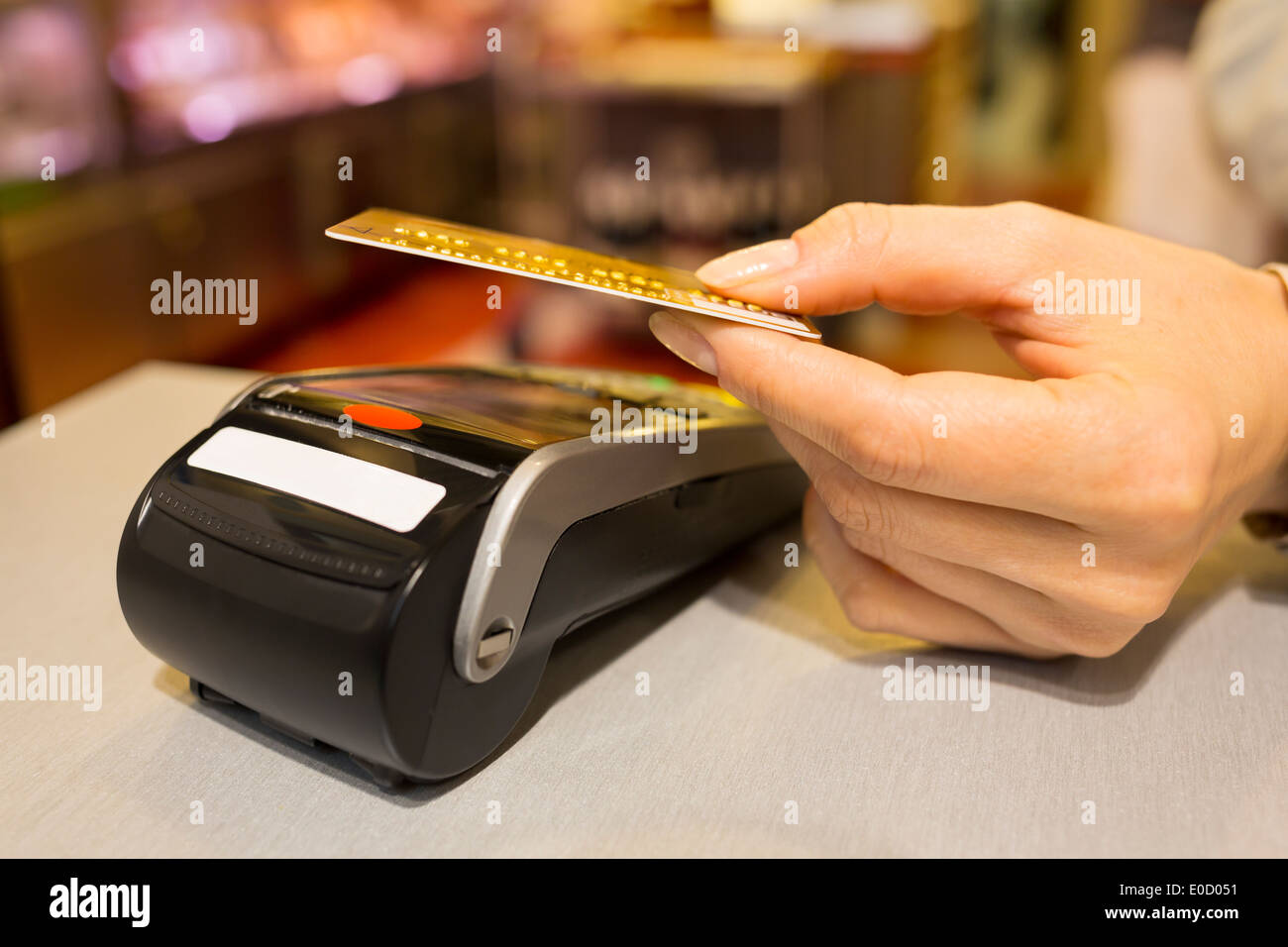 Femmina di pagare con carta di credito butcher shop Foto Stock