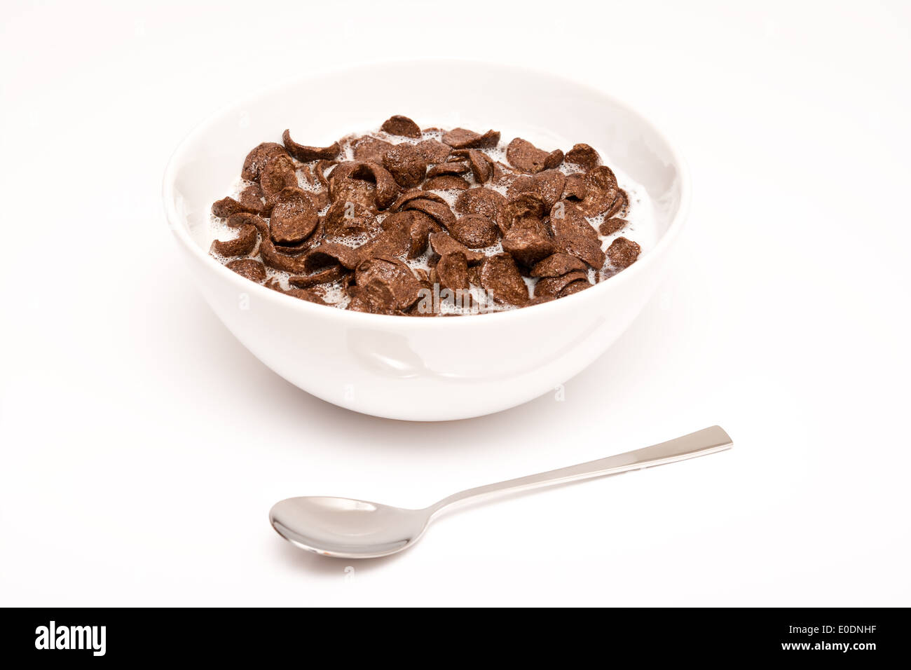 Il cioccolato Corn Flakes cereali ciotola e cucchiaio Foto Stock