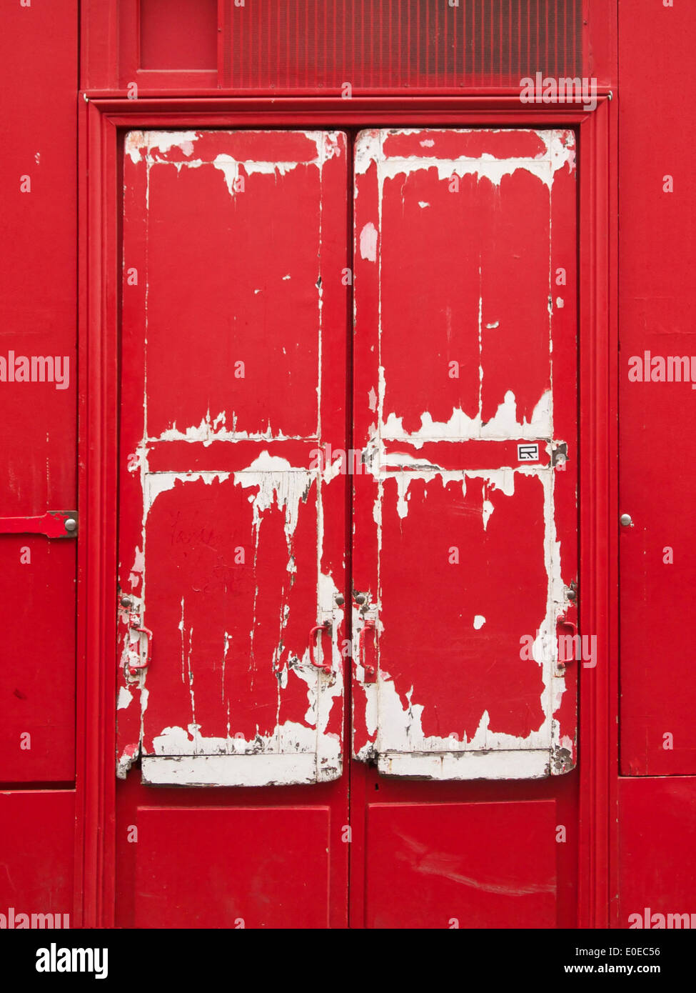 Primo piano verticale di una vecchia porta dipinta in rosso Foto Stock