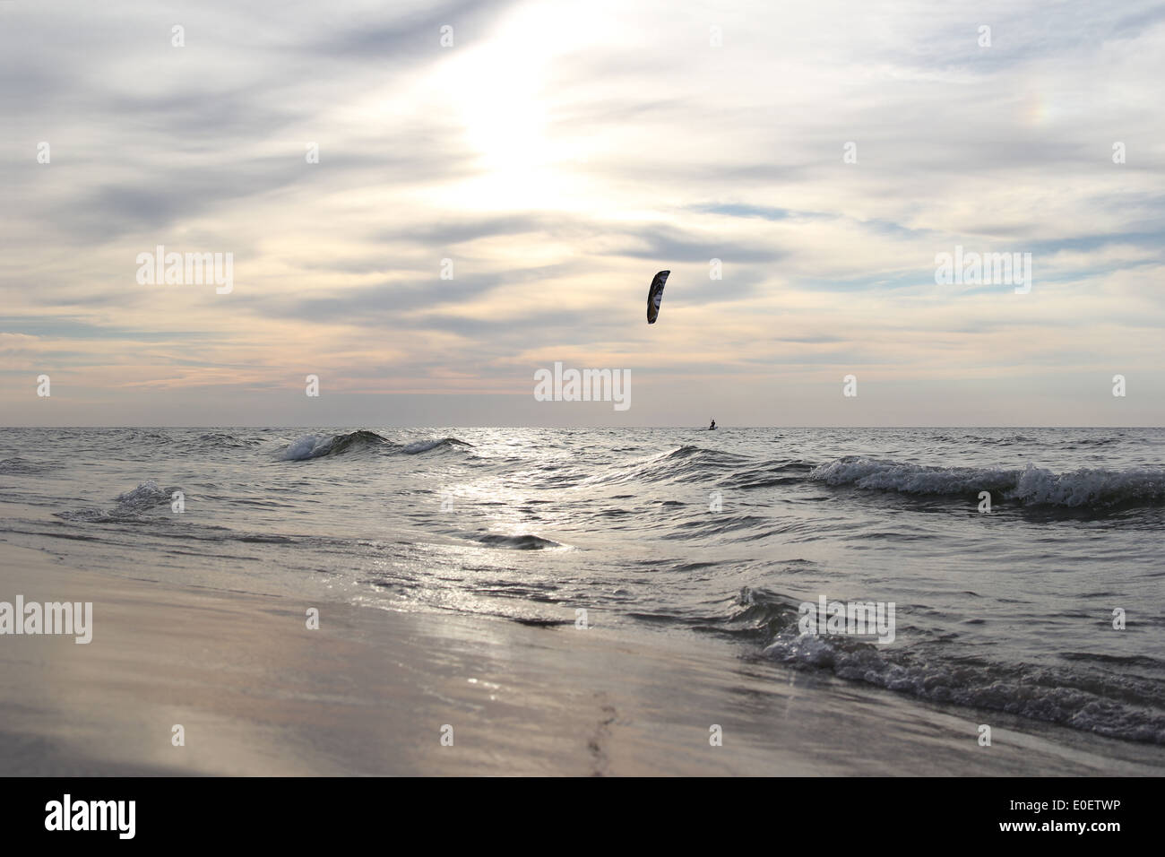 Mare con irriconoscibile silhouette di kitesurfer all'orizzonte Foto Stock