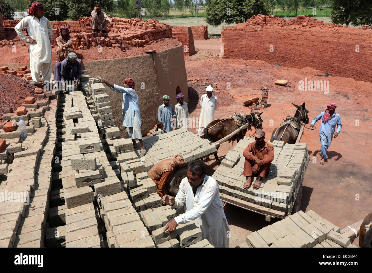 Gli uomini di mattoni di impilamento in un forno di mattoni di una fabbrica di mattoni, Lahore Punjab, Pakistan, Asia Foto Stock