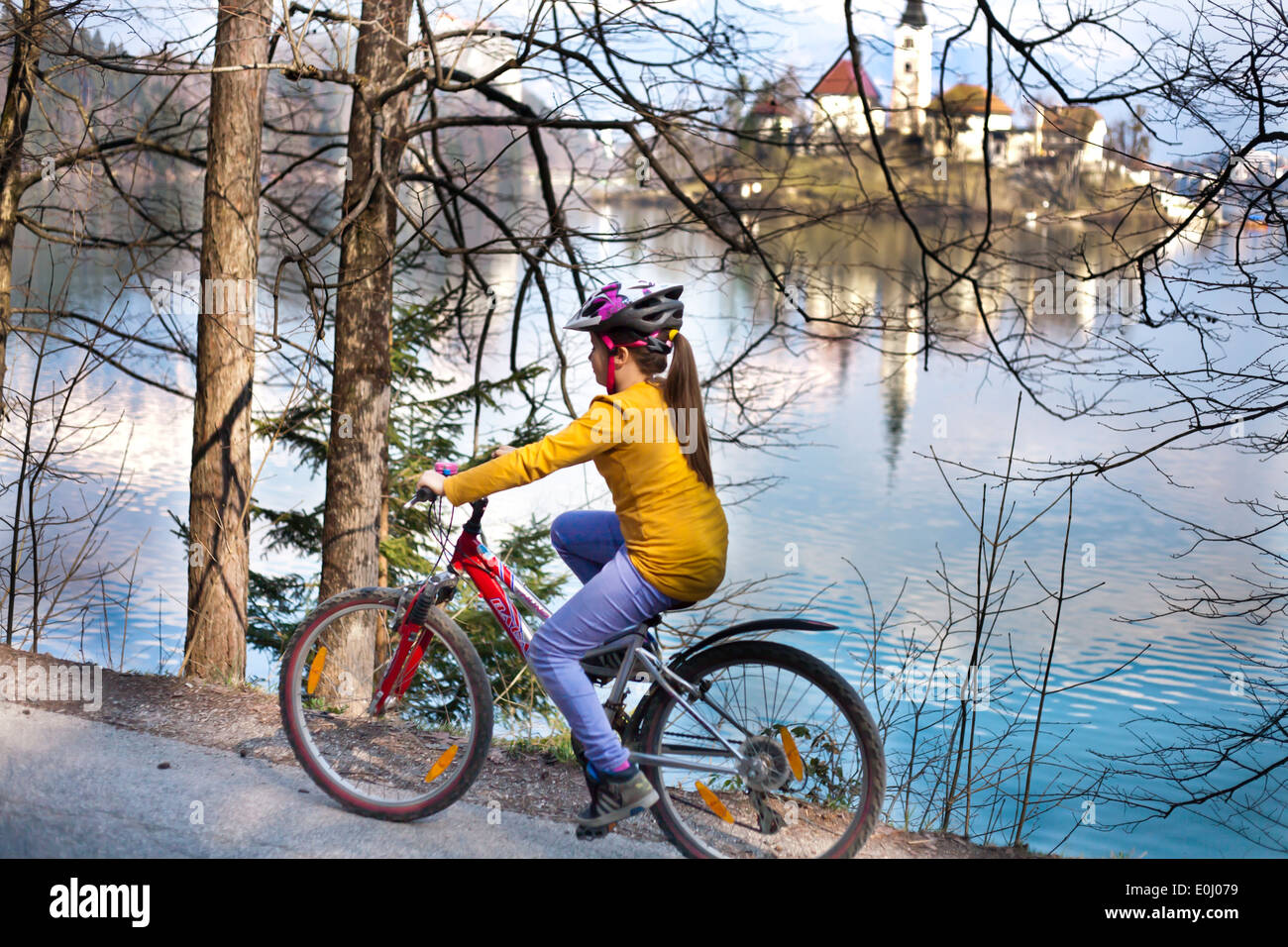 Ragazza in bicicletta intorno al lago di Bled, Slovenia. Foto Stock