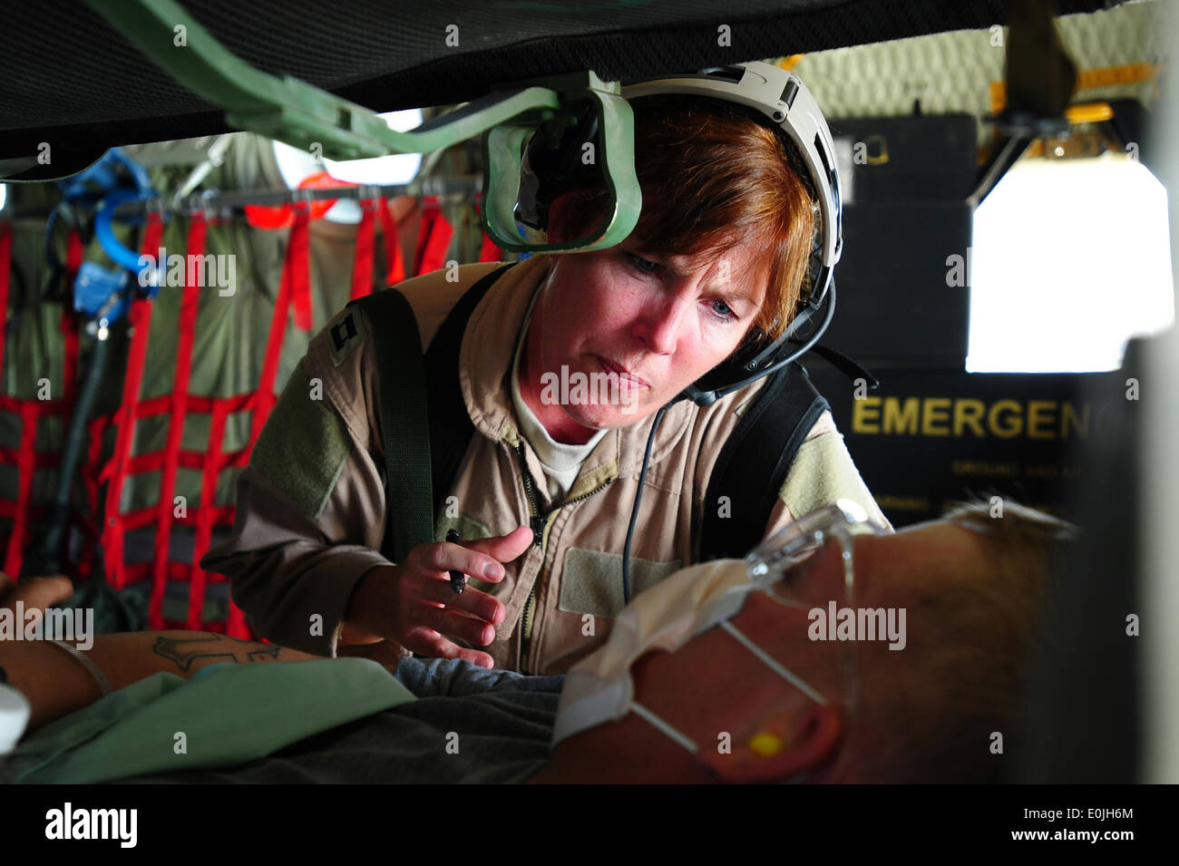 Il cap. Rita O'Brian, 379 Expeditionary evacuazione di medicina aeronautica squadriglia di volo, infermiere controlli su un paziente a bordo di una C-130 Hercul Foto Stock