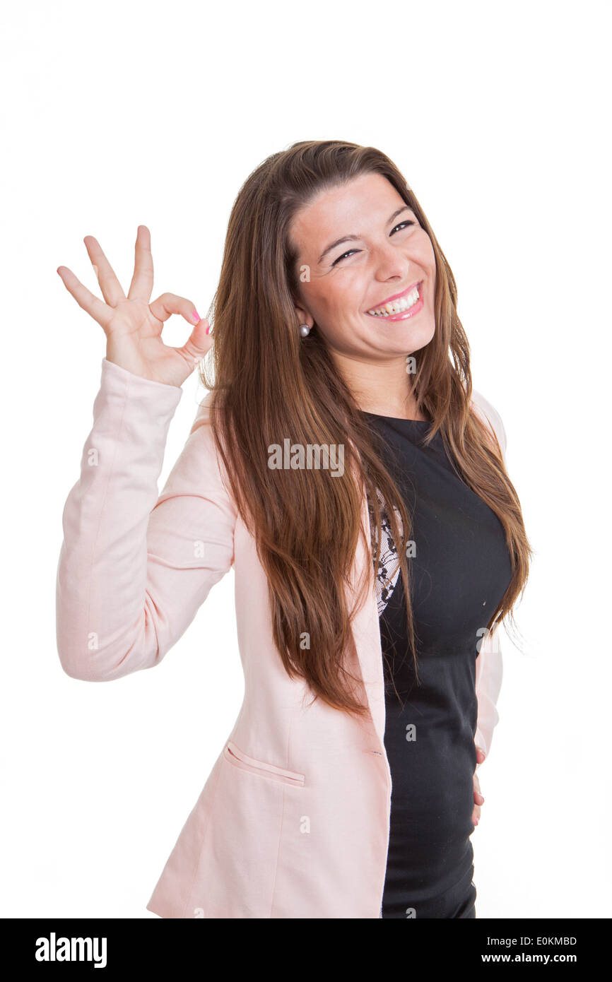 Sorridenti young business woman dando segno OK Foto Stock