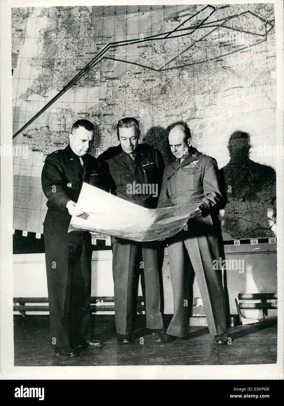 Apr. 04, 1945 - GENERALI PIANO DI ATTACCO DELL'ARIA. Il Comandante Generale dell'U.S. 8 Air Force Tenente Generale James H. DOOLITTLE si blocca su mappa meteo con due membri del suo staff. In piedi di fronte ad una mappa del percorso di una missione di Berlino. Generale Doolittle conferisce con il Brigadiere Generale Charles Y. BAWFILL, Direttore di intelligenza, 8 Air Force (sinistra) e il Maggiore Generale Orvil A.Anderson, Vice comandante generale per operazioni, 8 Air Force (centro) Foto Stock