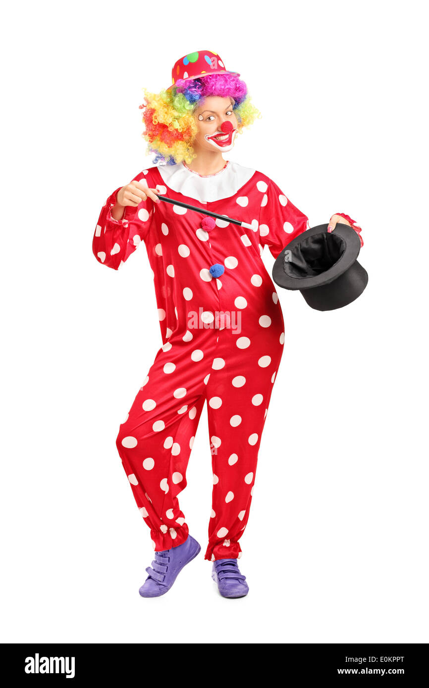 A piena lunghezza Ritratto di una donna clown tenendo un mago hat Foto Stock