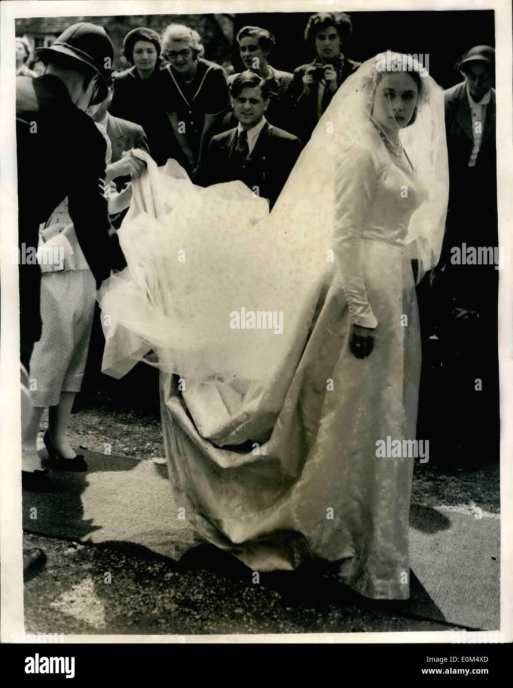 Lug. 07, 1953 - ROYAL GLI OSPITI DI NOZZE PAESE...poliziotto organizza la sposa del treno. La regina madre e la principessa Margaret erano tra gli ospiti di nozze questo pomeriggio al St. Mary's Hambeldon, della HON. LAURA SMITH di 21 anni, figlia di Lord e Lady Hambeldon e il sig. MICHAEL BRAND 28 enne figlio di Lady Rosabelle marca... KEYSTONE foto mostra: un punto di assistenza per organizzare la sposa del treno - da un poliziotto come la sposa è arrivata per il matrimonio di questo pomeriggio. Foto Stock