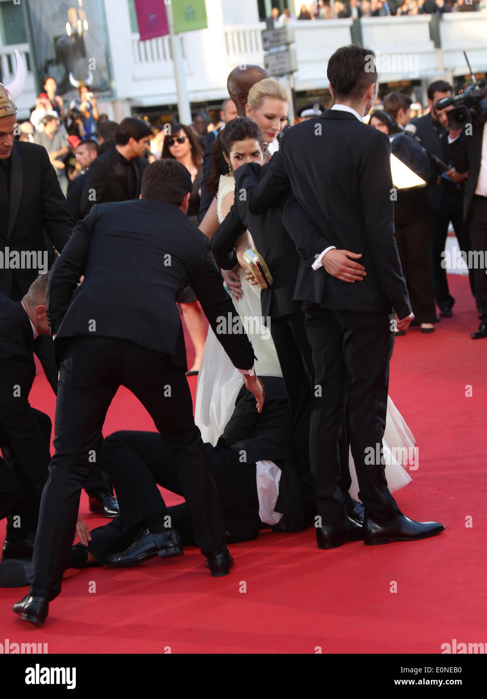 Le guardie di sicurezza trattengono un uomo che ha raccolto sotto il vestito di attrice statunitense America Ferrera come lei arriva per lo screening di 'Come addestrare il vostro drago 2' durante la 67th annuale di Cannes Film Festival di Cannes, Francia, 16 maggio 2014. Il film è presentato fuori concorso al festival che corre dal 14 al 25 maggio. Foto: Hubert Boesl Foto Stock