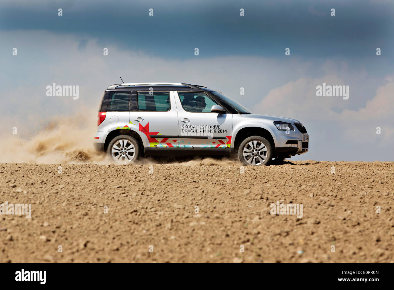 Un SUV con i giornalisti scorre attraverso un campo per visualizzare una gigantesca statua di bielorusso simbolo nazionale, il Bisonte Europeo, su una autostrada che conduce a Minsk, Bielorussia, Sabato, Maggio 10th, 2014. Le autostrade in Bielorussia non conformi con West norme europee. Western Foto Stock