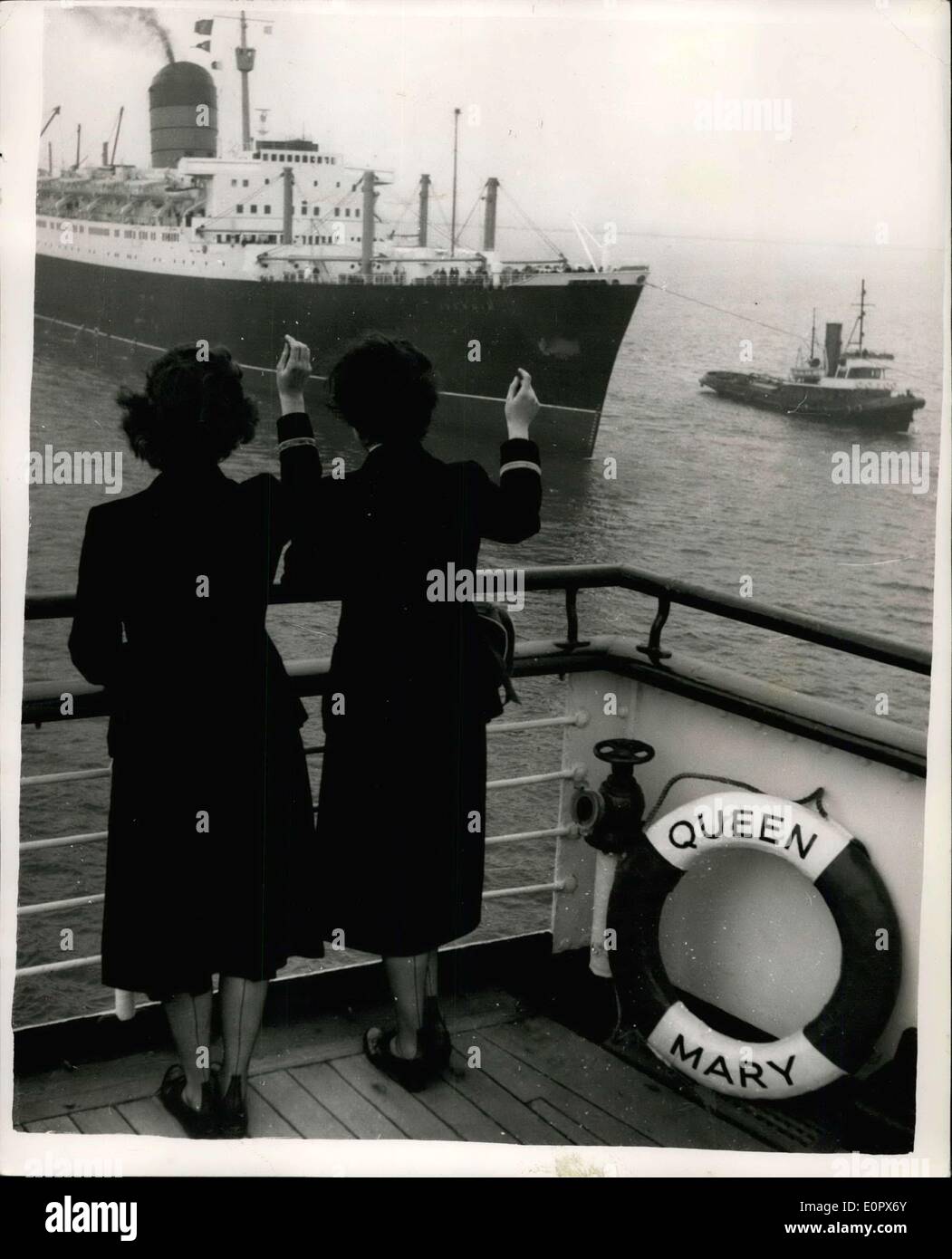 Apr. 02, 1957 - La regina Maria approda a Cherbourg per battere il Southampton Dockers ban... Il liner Queen Mary ieri attraccata a Cherbourg e i passeggeri vengono traghettato a Plymouth a bordo della SS Invernia. Questo perché la dichiarazione "in nero" del gigante rivestimento mediante gli scaricatori di porto a Southampton. Keystone Foto Mostra: due membri dell'equipaggio a bordo della Queen Mary onda da rivestimento della SS Invernia arriva al posto di ormeggio a fianco di Cherbourg. Foto Stock