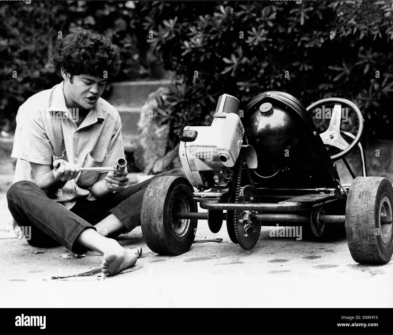 Monkee Micky Dolenz lavorando sul suo go-kart Foto Stock