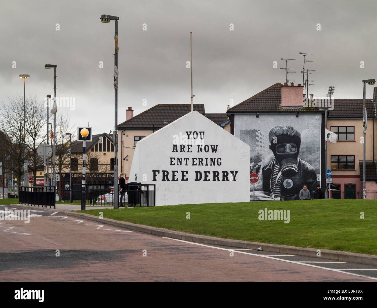 Segno di entrare gratis Derry con murale di Bogside artisti sul lato della casa in Derry, Irlanda del Nord Foto Stock