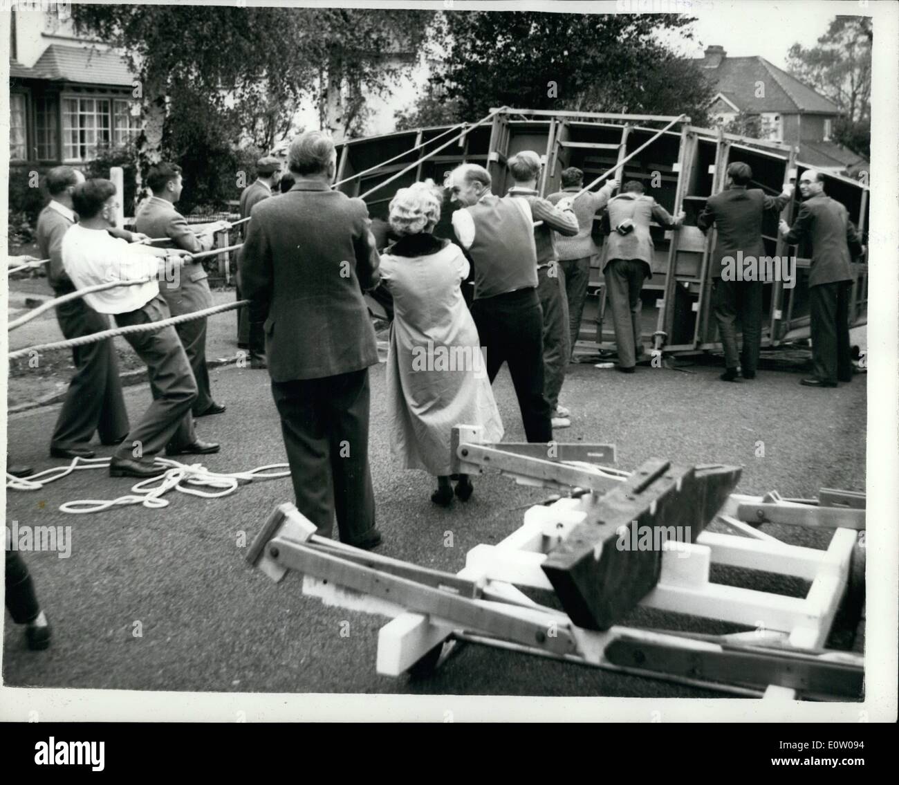 Ottobre 10, 1960 - ha costruito la sua propria barca nel suo giardino frontale recluta un piccolo esercito di capovolgerlo.: Sei anni fa - il sig. Sant - Chi è un appassionato di yaschtsman e chi vive a Carshalton Beeches, Surrey avviato i lavori per la costruzione di uno yacht nella sua camera anteriore. Quando l'imbarcazione ha iniziato a crescere aveva a laurearsi alla parte anteriore di una trasmissione che ha coperto in modo che egli possa lavorare in tutta comodità sul gruppo principale del suo 25 ft. lungo Bermuda rigged sloop che sarà dotato di un piccolo motore ausiliario quando completato Foto Stock