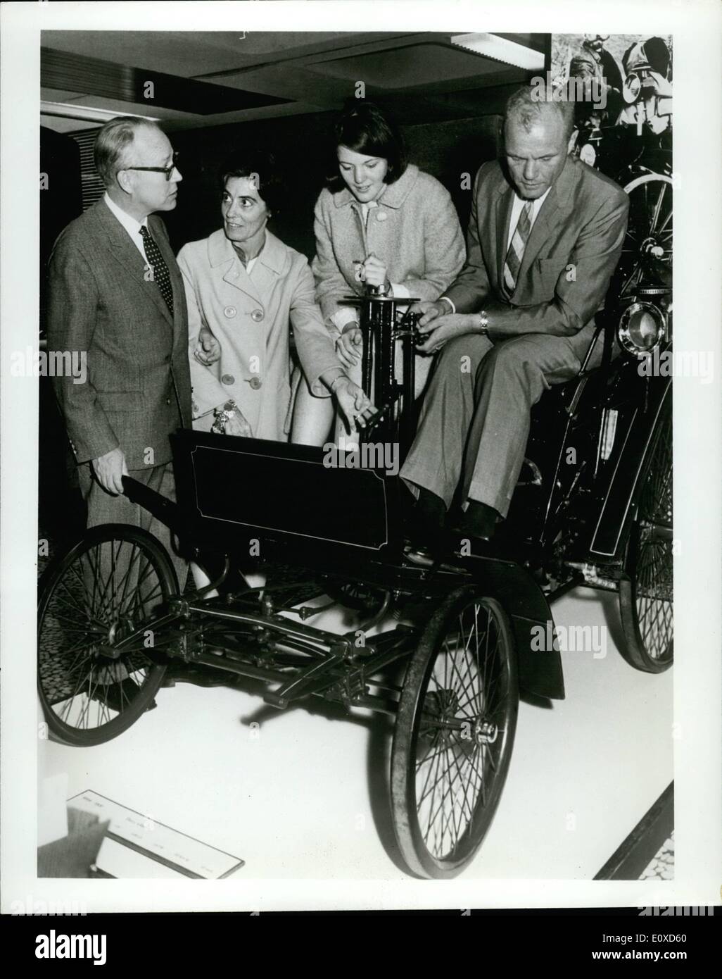 Giugno 06, 1966 - Un nuovo tipo di ''capsula'': Col. John F. Glenn, astronauta americano, tenta di eseguire i comandi del mondo la prima produzione automobilistica, 1894 Benz Velo, durante la sua recente visita alla fabbrica di Daimler-Benz a Stuttgart, Germania. Il dottor Joachim Zahn, Altoparlante del consiglio di amministrazione della Daimler-Benz AG, spiega la vettura al Col. Glenn, la moglie Anna e sua figlia, Carolyn. Foto Stock