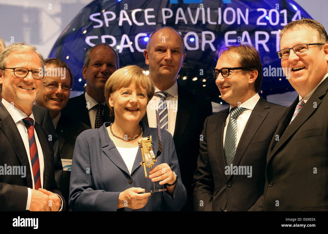 Il cancelliere tedesco Angela Merkel, tenendo un modello del satellite meteorologico, Premier di Brandeburgo Dietmar Woidke (C), e il ministro dei Trasporti tedesco Alexander Dobrindt (2-R) a prendere parte a una firma del contratto per quattro satelliti meteorologici a ILA Berlin Air Show 2014 in Selchow, Germania, 20 maggio 2014. L'Agenzia Spaziale Europea ha ordinato quattro satelliti da Airbus la divisione spazio per 1,2 miliardi di euro. Il settore aerospaziale e della difesa mostra insutry avviene sulla zona a sud di Berlino-Schoenefeld airport dal 20 fino al 25 maggio 2014. Foto: WOLFGANG KUMM/DPA Foto Stock
