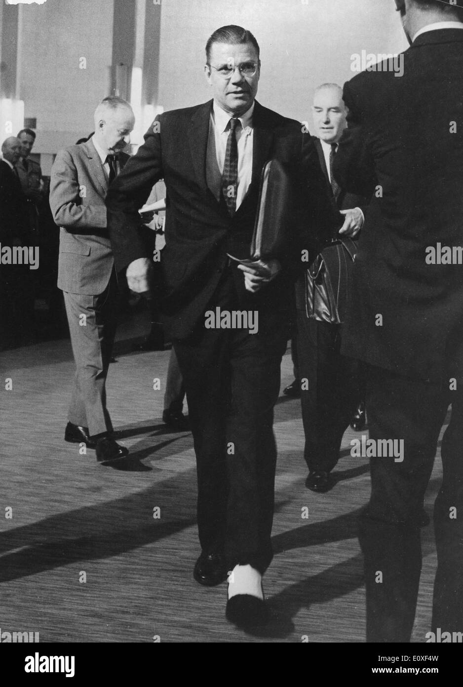 ROBERT MCNAMARA, gli Stati Uniti il Segretario della Difesa, passeggiate con la sua gamba intonacata alla sede centrale, dopo il suo incidente. Foto Stock