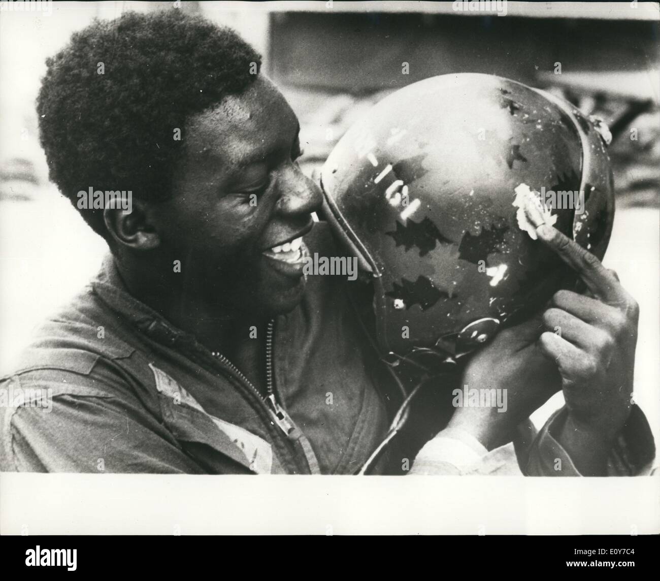 Apr. 04, 1969 - Chiudere la chiamata PER GLI STATI UNITI Marina: Pro Sam Hampton U.S. Marine è in grado di sorridere mentre punta a una 50 Caliber bullet incorporato nel suo acciaio casco dopo un Viet Cong gunner sparato al suo mentre lui era in un elicottero su una evacuazione medica volo. Foto Stock