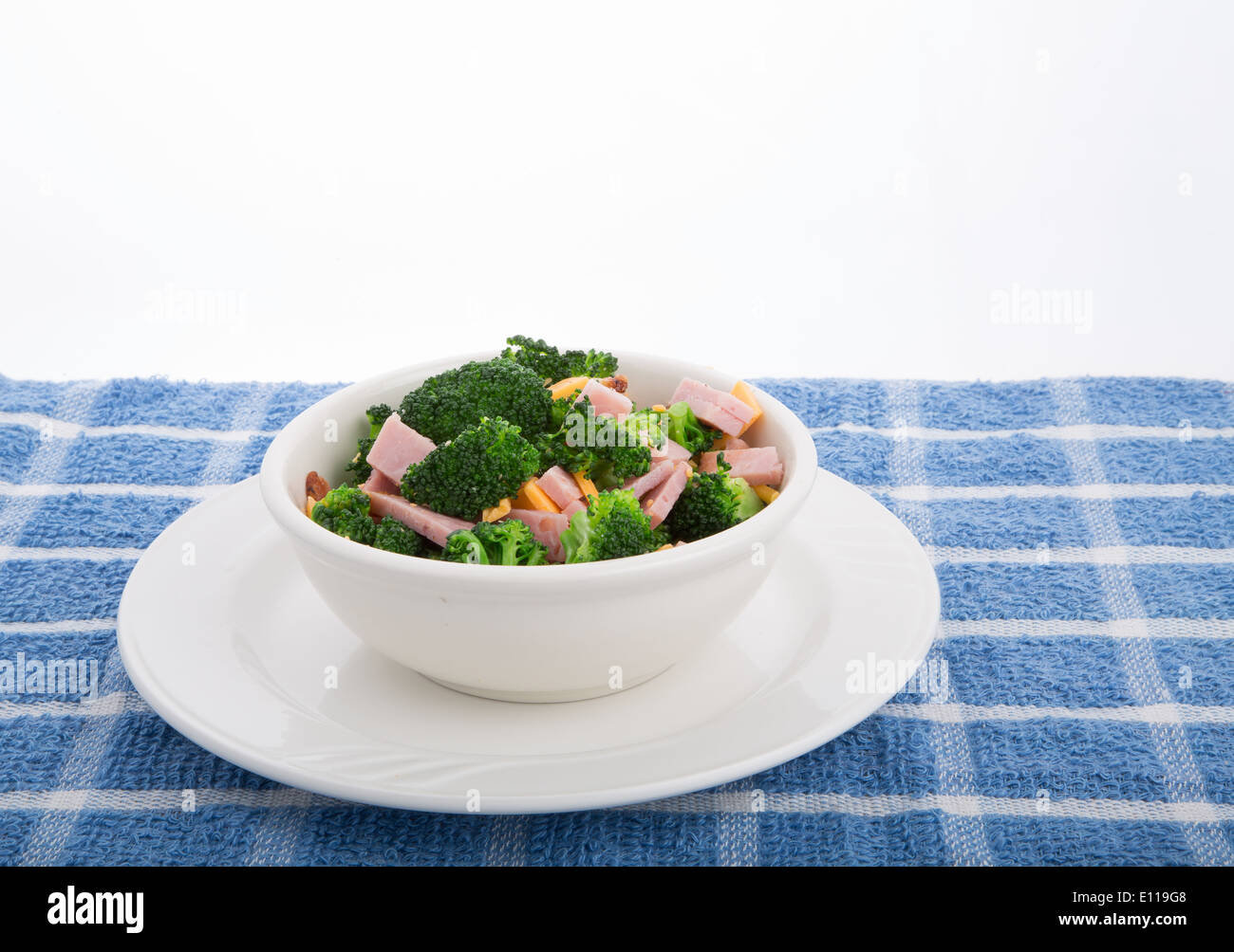 Una fresca insalata di broccoli verdi, fette di prosciutto e formaggio Cheddar grattugiato Foto Stock