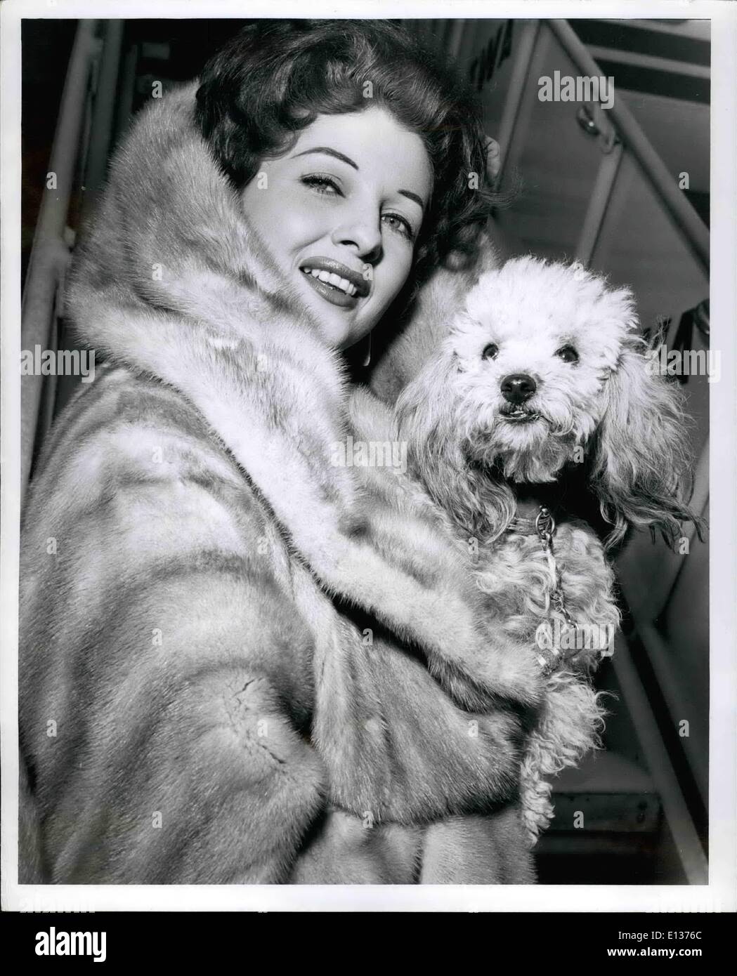 Febbraio 29, 2012 - Edoardo Vianello aeroporto, N.Y., gen. 27 - ''Stormy'' Tassi veramente - come si vede qui di essere protetti contro il nostro clima invernale con la sua padrona, danzatrice esotica, Tempest Storm prima di salire a bordo di un TWA Jetstream per più soleggiato perso Angeles. Tempesta sta tornando a casa sua a seguito di un Night Club di impegno in città. Foto Stock