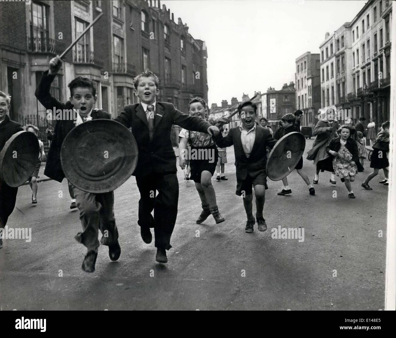 Apr. 17, 2012 - i difensori del play street; con la pattumiera coperchi per le protezioni e i pezzetti di legno per lance, i giovani cavalieri di difendere il loro gioco street dall'invasione del fotografo. Questa strada, messo da parte come un gioco street per i bambini, è nella zona densamente popolata off il Harrow Road a Paddington. Foto Stock